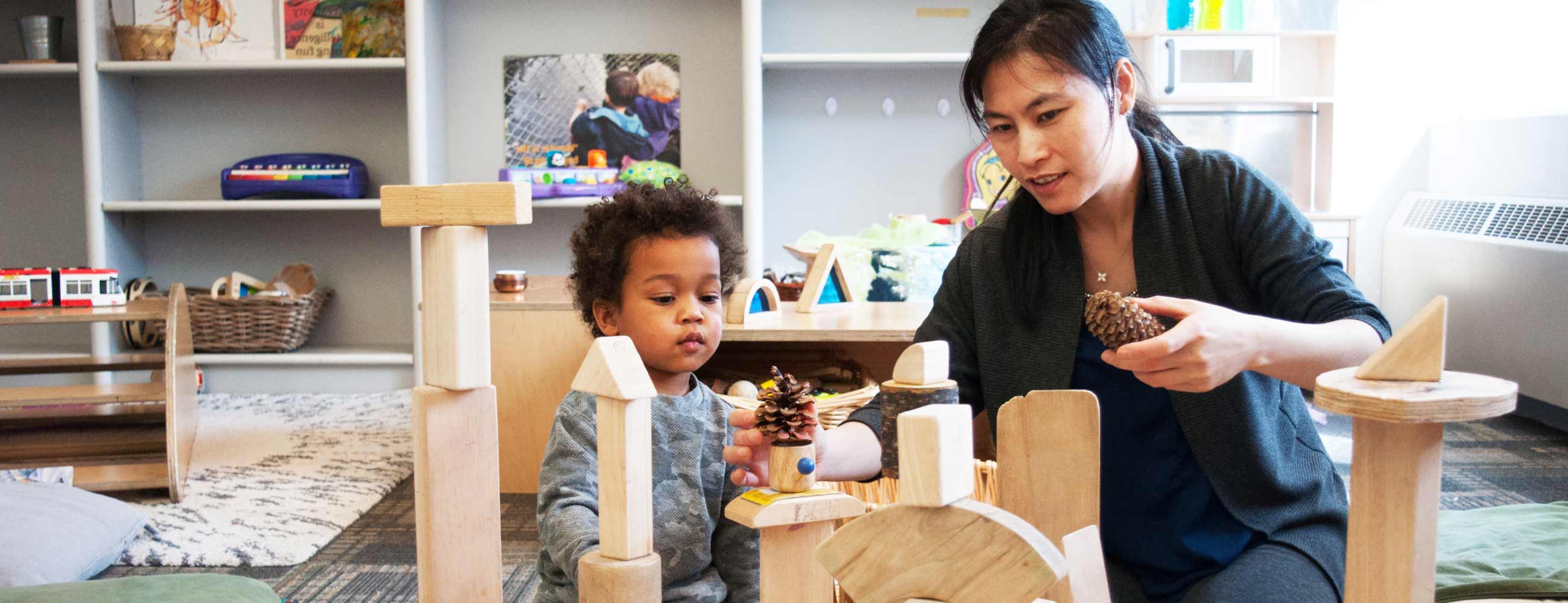 child-and-care-provider-playing-with-blocks.jpg